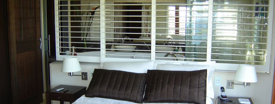 Traditional room design in Brisbane, featuring Plantation Shutters from Norman. Installed by Complete Blinds.