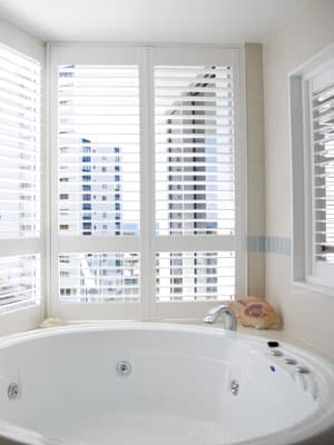 View of opulent bathtub, featuring Plantation Shutters by Norman. Installed by Complete Blinds Brisbane.