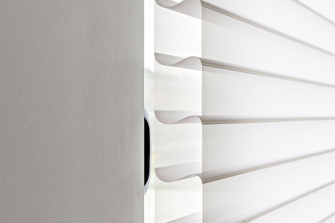 Close-up image of Silhouette Shades with signature S-Vanes diffusing sunlight and naturally brightening the room. Elegant design with UV protection. Available at Complete Blinds Brisbane.