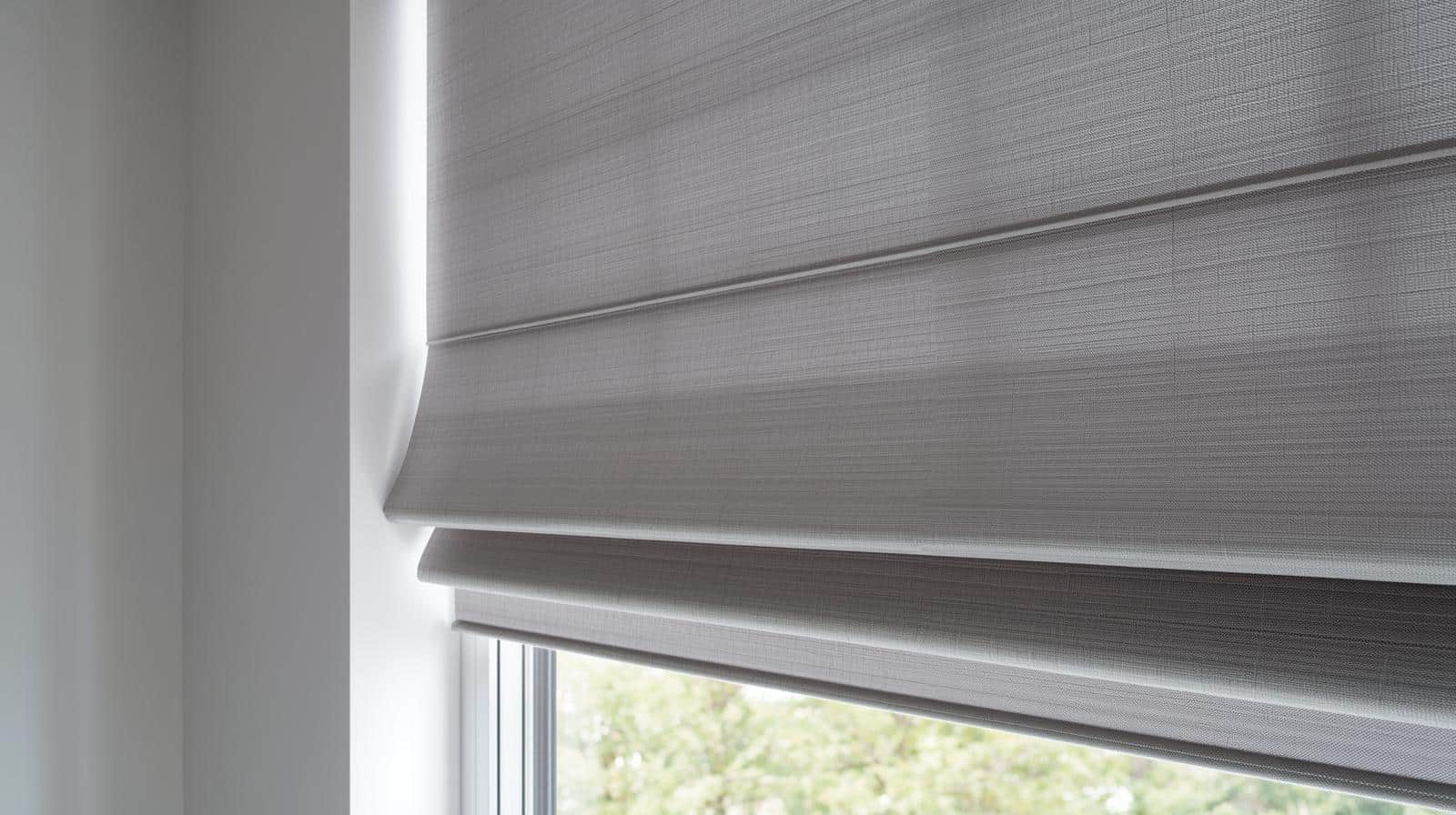 Modern minimalist room featuring grey Roman Blinds for privacy and temperature control by Complete Blinds Brisbane