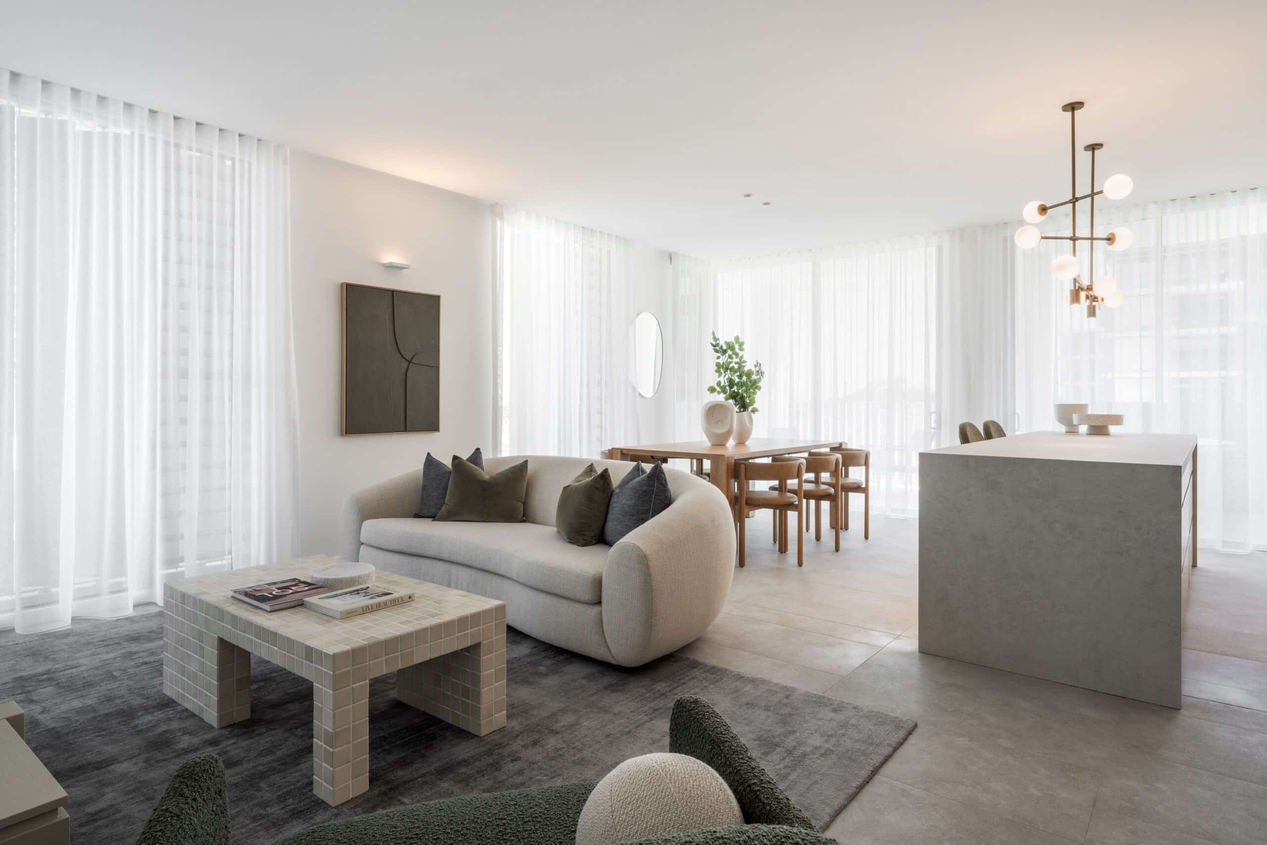 Modern contemporary aesthetic living room, grey and white theme, featuring sheer white curtains by Complete Blinds Queensland.