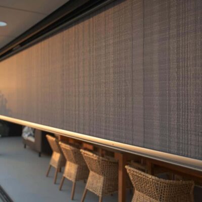 Zip‑track outdoor blind enclosing a Brisbane alfresco for wind and insect control