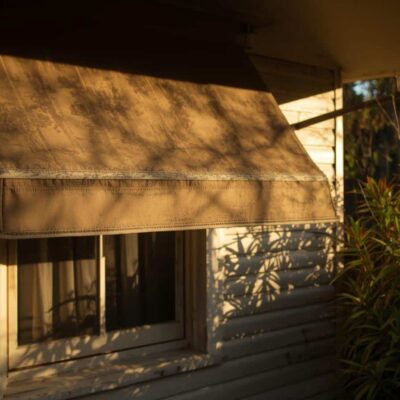 Window awning shading a west-facing window from afternoon sun