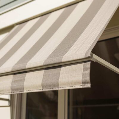 Stylish fabric window awnings on a Brisbane home exterior adding shade and street appeal